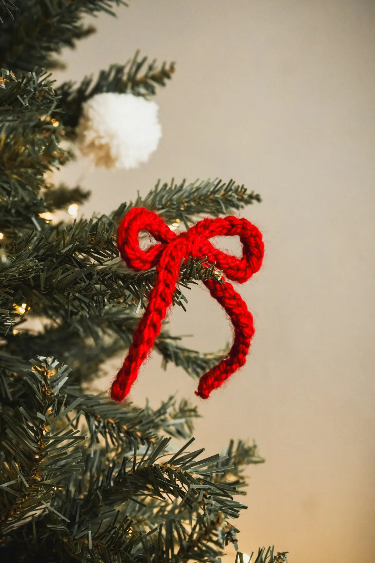 a close-up view of a beautifully decorated Christmas tree featuring handmade crochet and felt ornaments