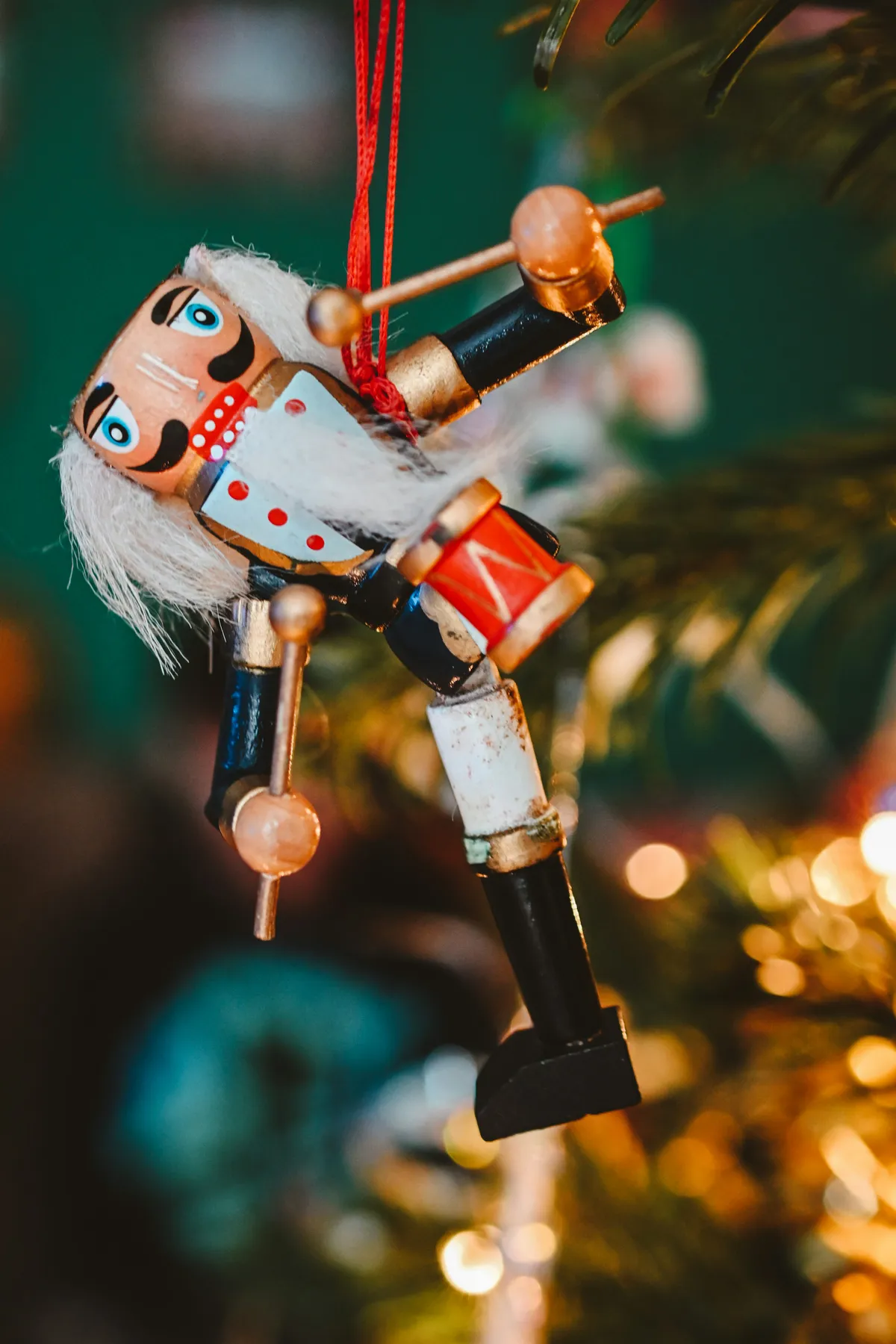 A nutcracker ornament hanging from a christmas tree - Free Photo on Unsplash