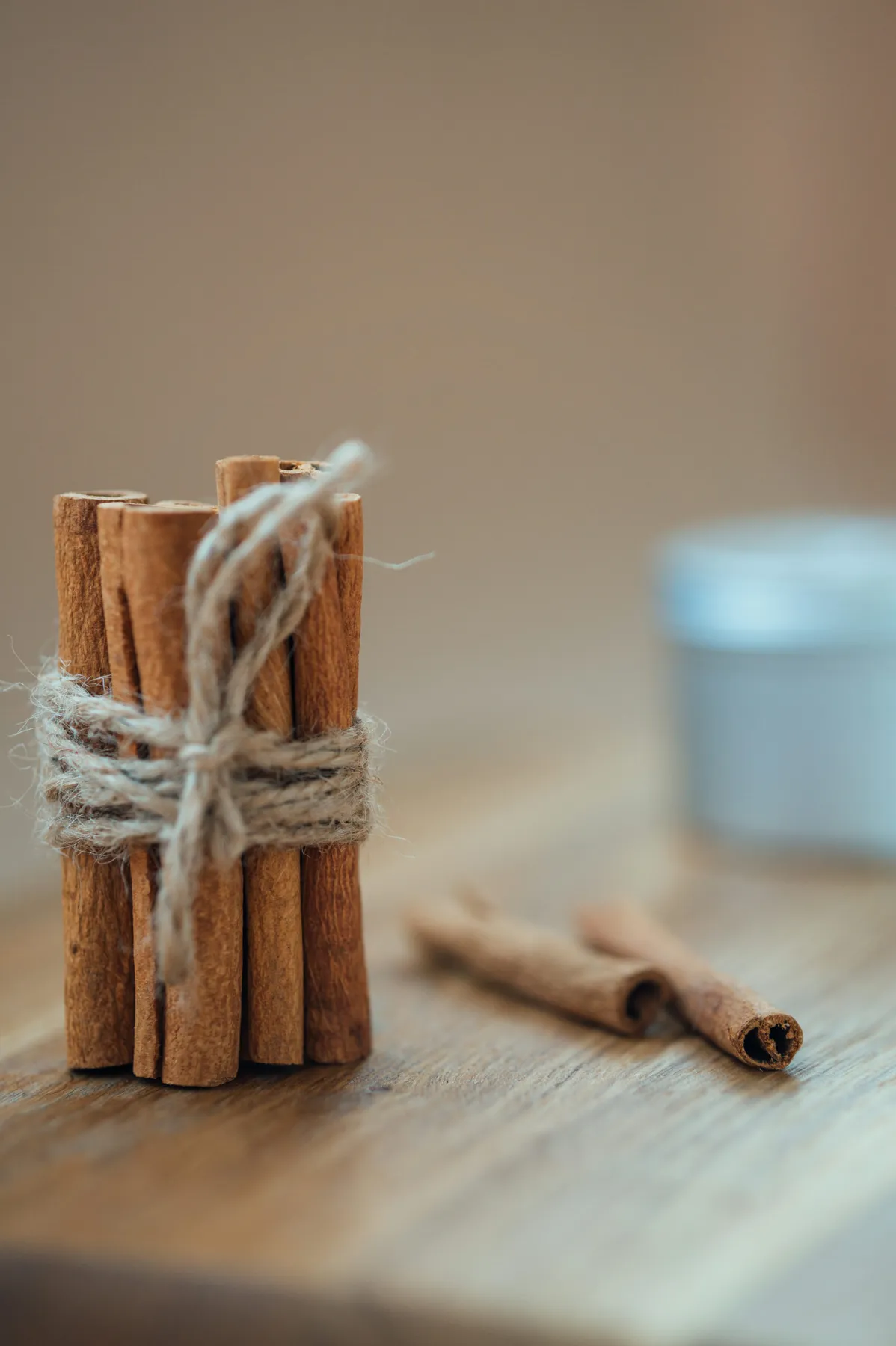 A roll of twine and cinnamon sticks on a white wood floor - Free Photo on  Unsplash