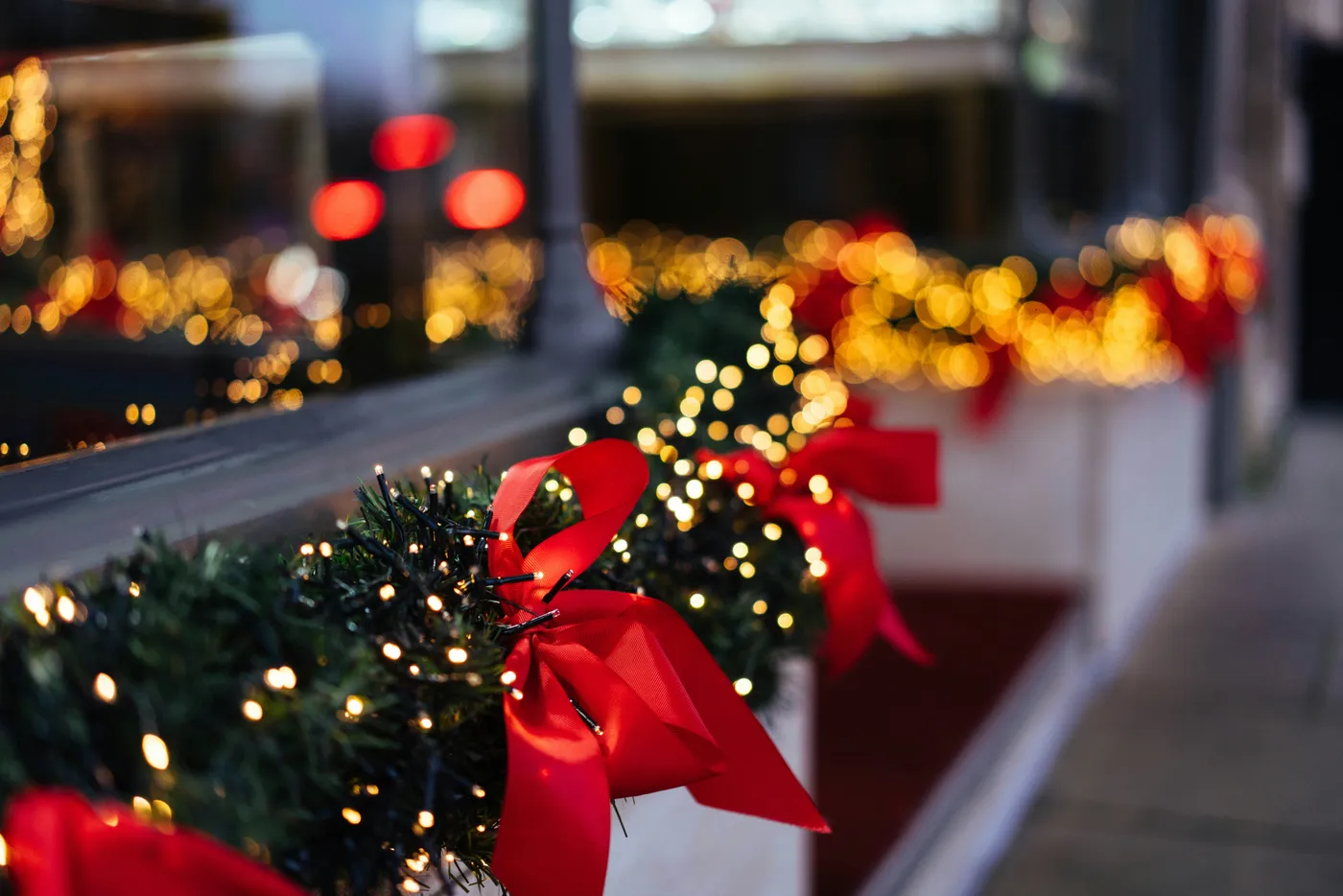 A row of christmas trees with red bows on them