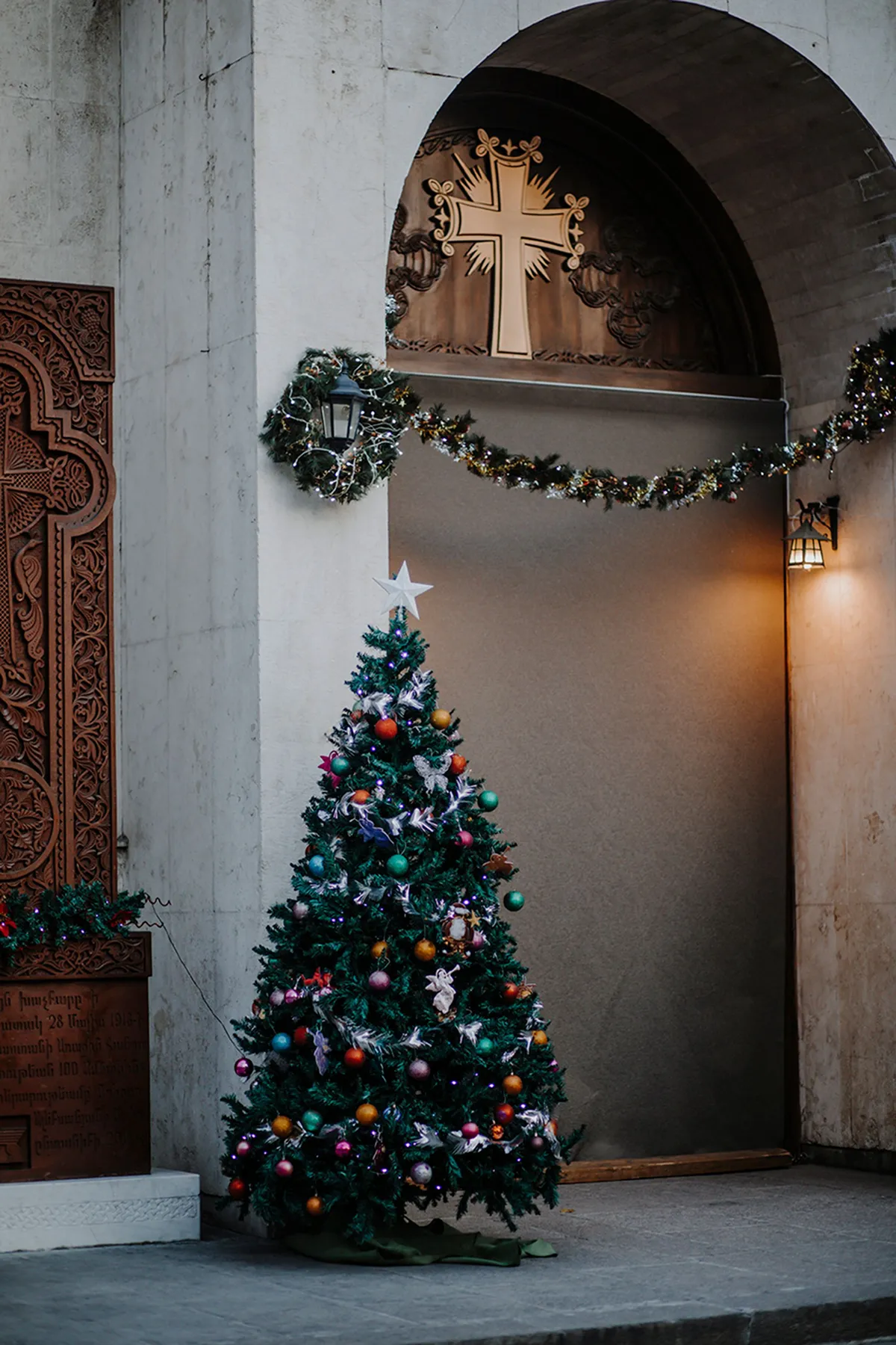 A serene church entrance adorned with a Christmas tree and decorations, embodying holiday spirit.
