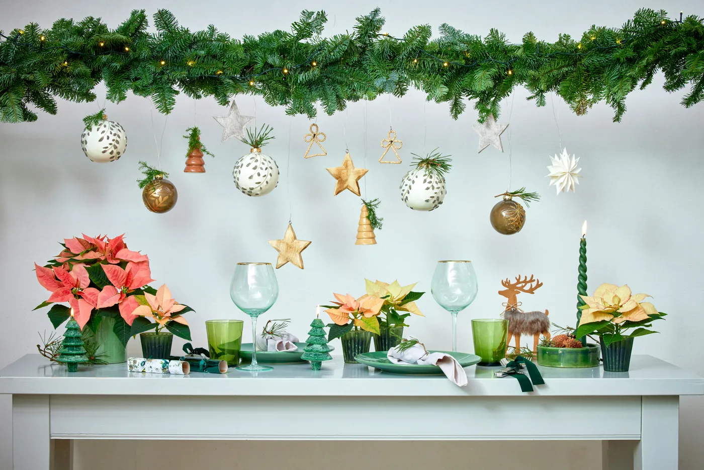 Beautiful Christmas tablescape with poinsettias and hanging baubles. Image credit: Stars for Europe