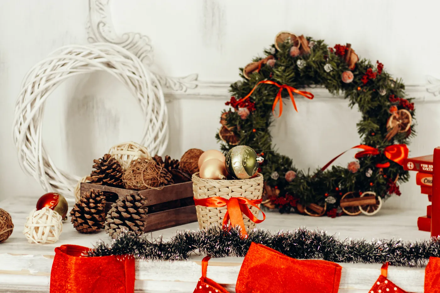 Charming Christmas display featuring a wreath, ornaments, and pine cones for holiday decor.