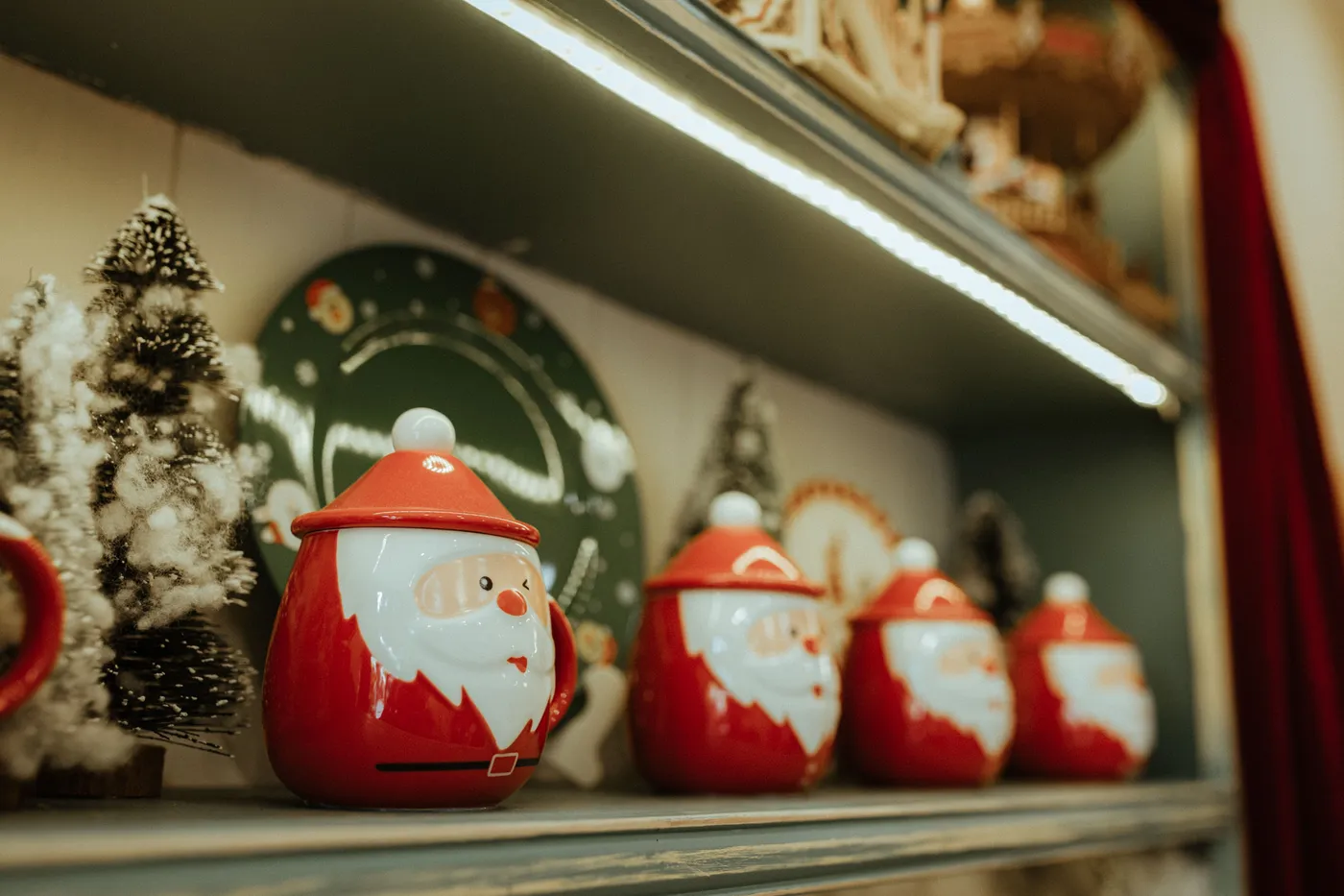 Charming Santa-themed jars and wintry decor on a festive Christmas shelf display.