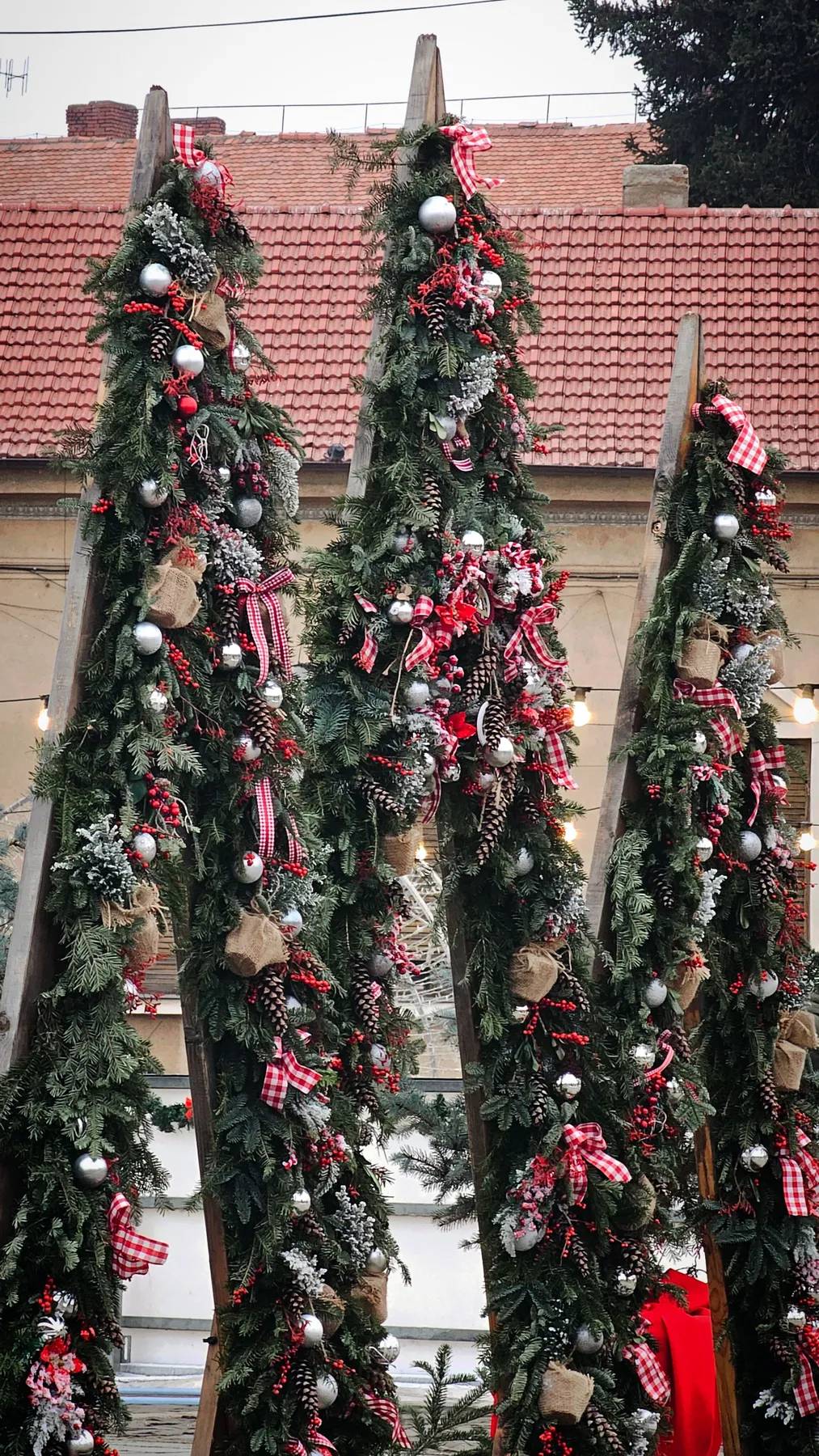 Christmas decorations with pine greenery, red bows, and ornaments creating a festive atmosphere.
