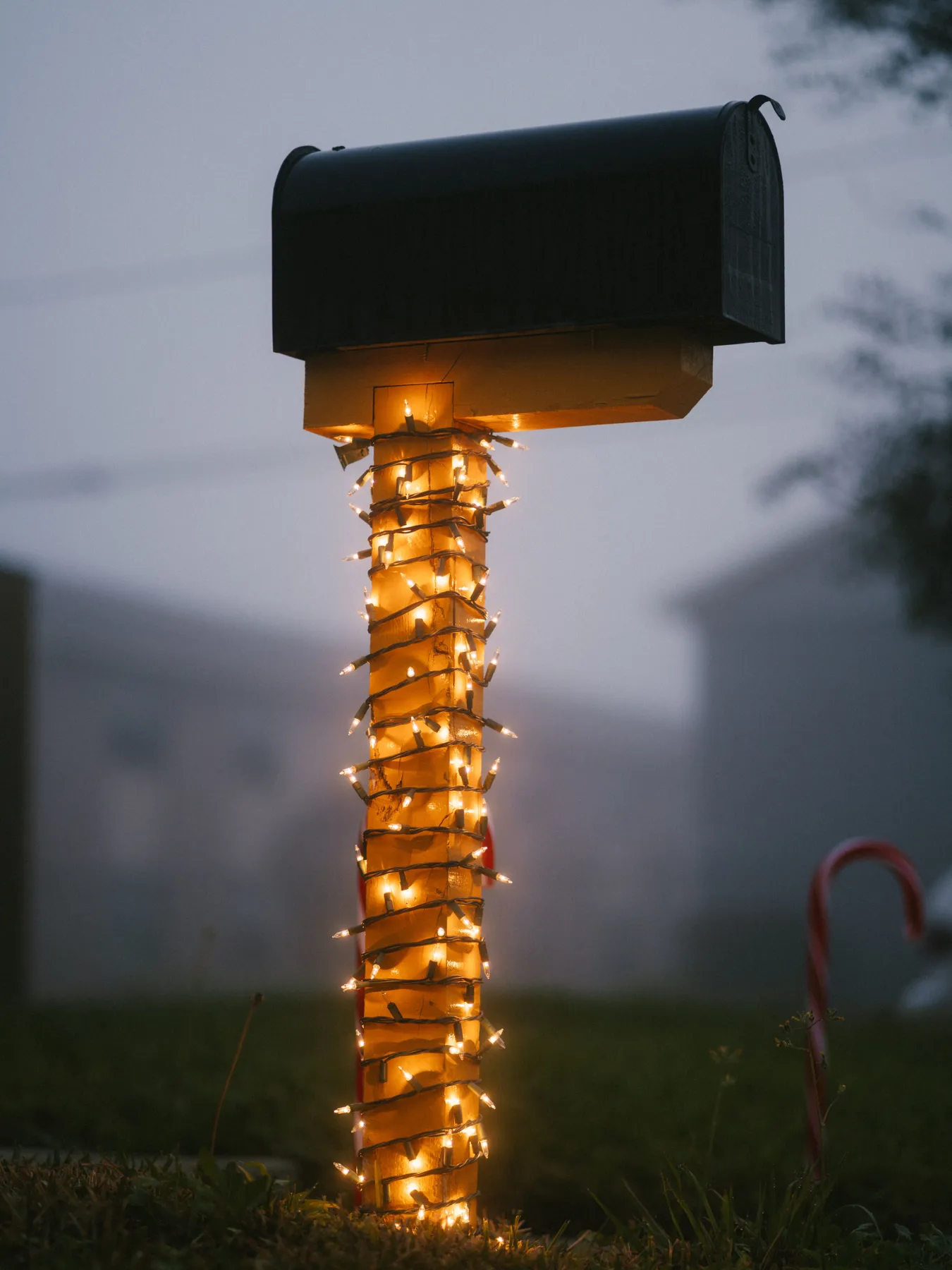 Christmas mailbox wrapped with lights, creating a warm holiday ambiance.