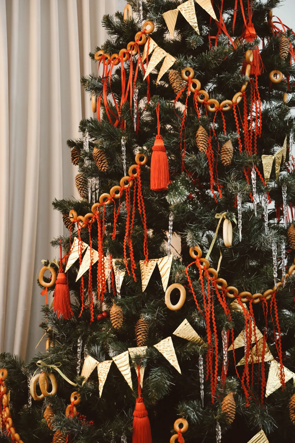 Christmas tree adorned with red and gold decorations, perfect for holiday ambiance.