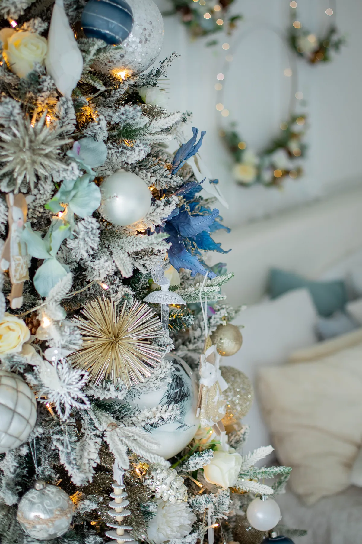 Close-up of a beautifully decorated Christmas tree adorned with silver and blue ornaments, showcasing holiday spirit.