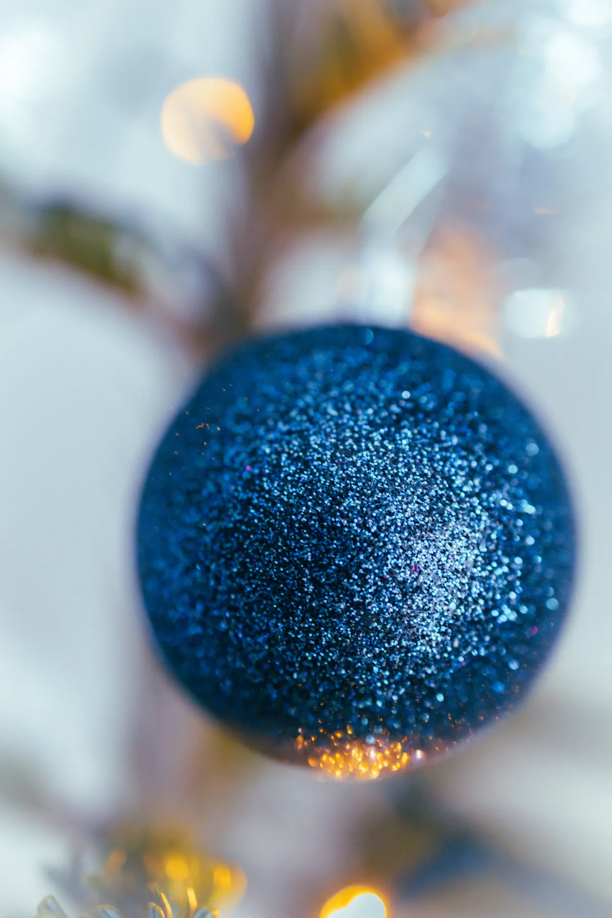 Close-up of a glittering blue Christmas ornament, perfect for holiday decor themes.