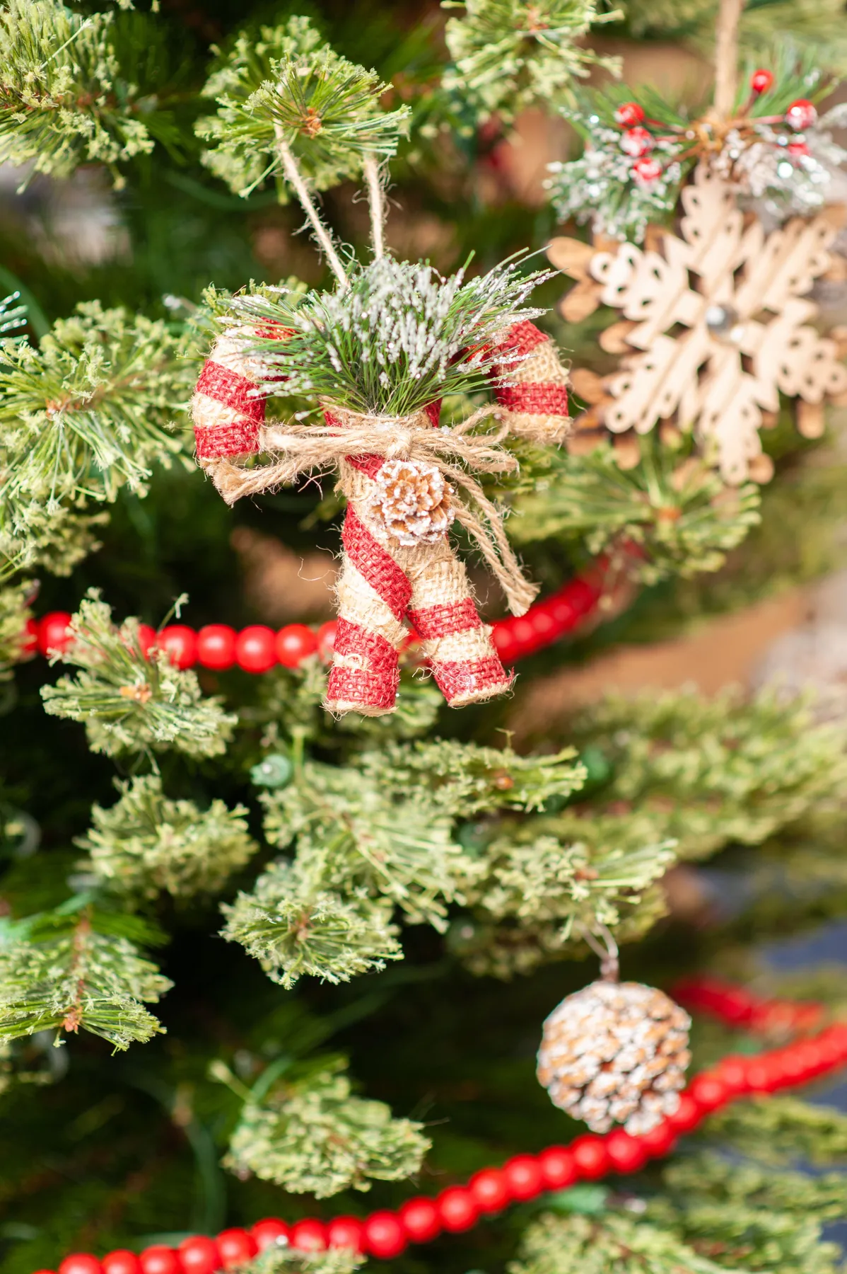 Detailed view of rustic Christmas ornaments on a festive tree.