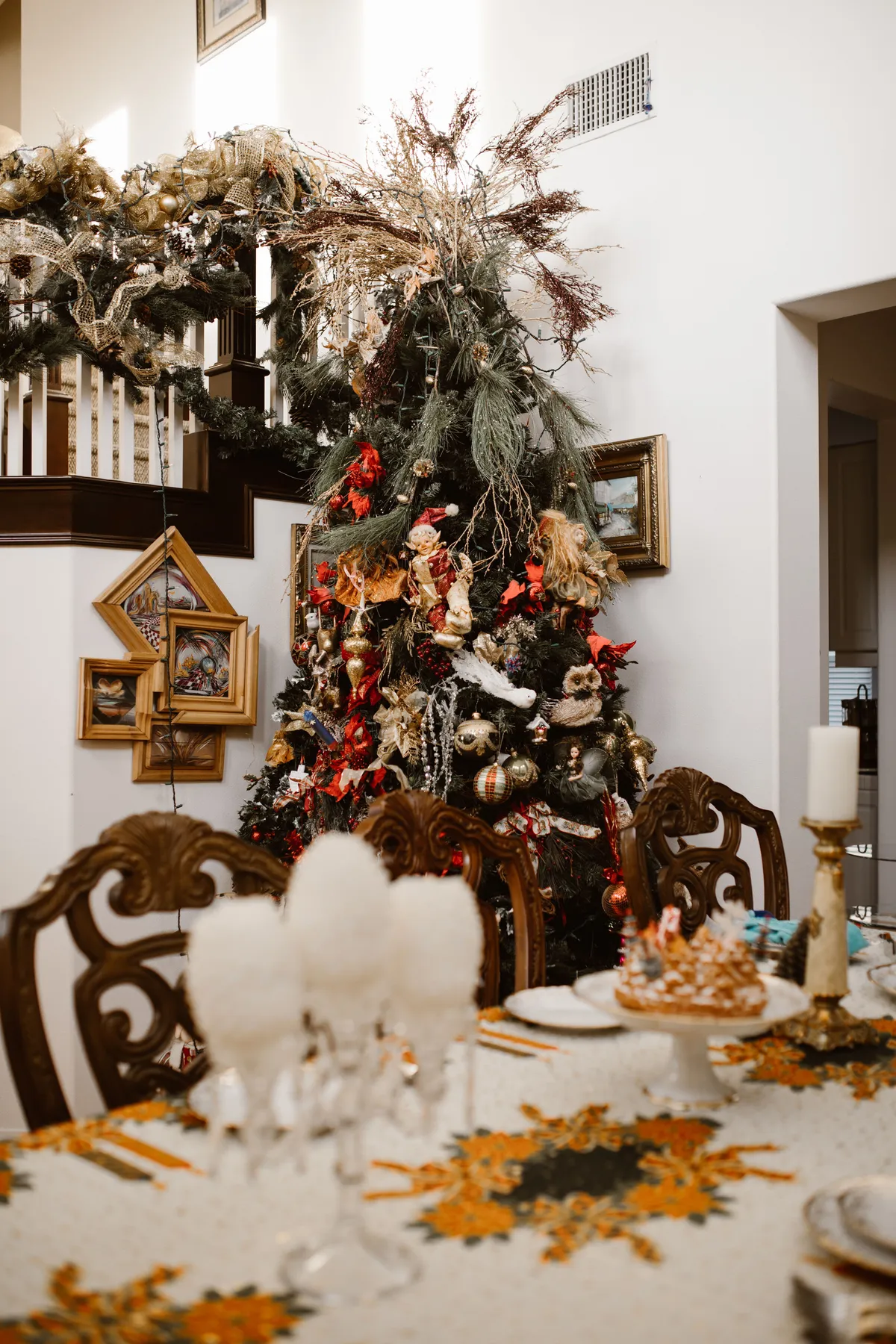 Elegant dining room adorned with a beautifully decorated Christmas tree and festive table setting.