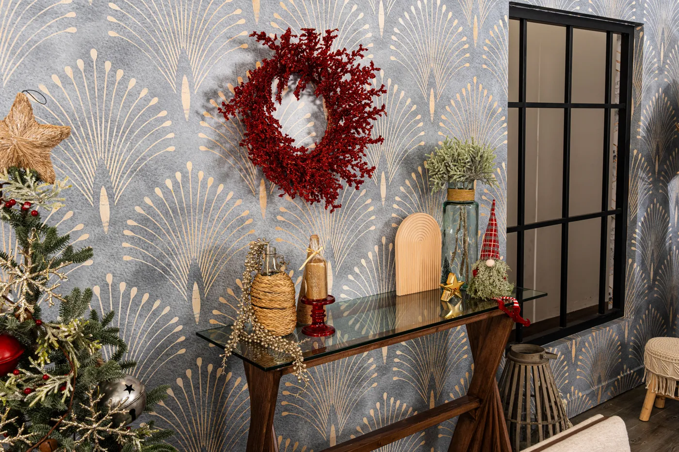 Elegant interior with festive Christmas decorations and a red wreath on patterned walls.