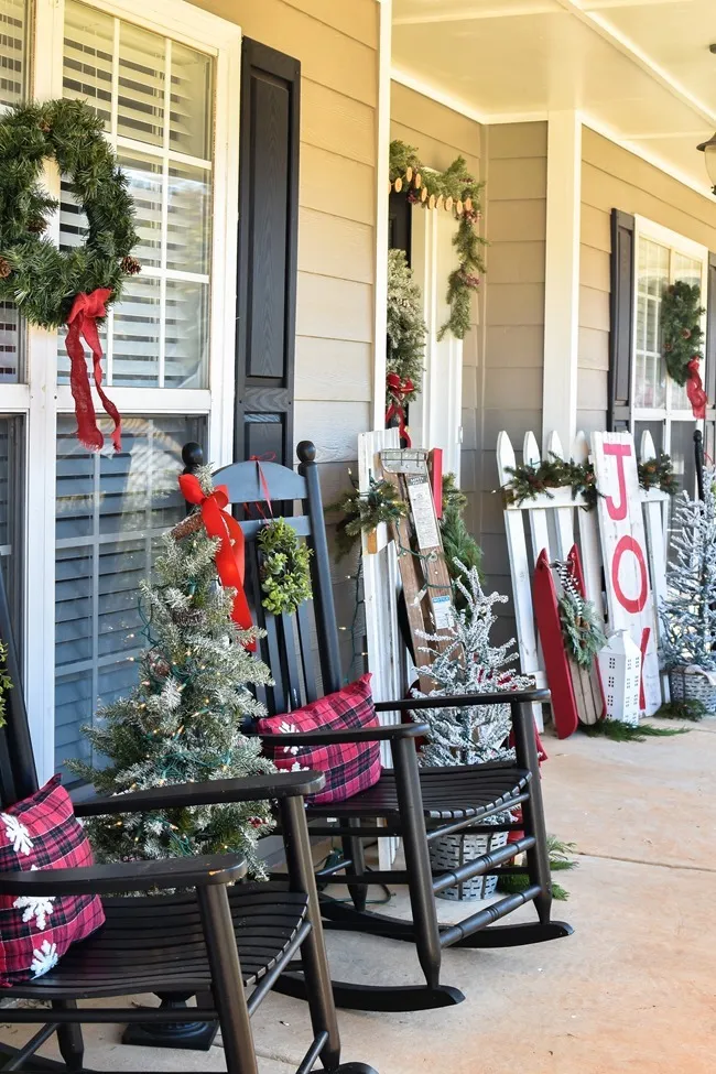Farmhouse style Christmas front porch with picket fences