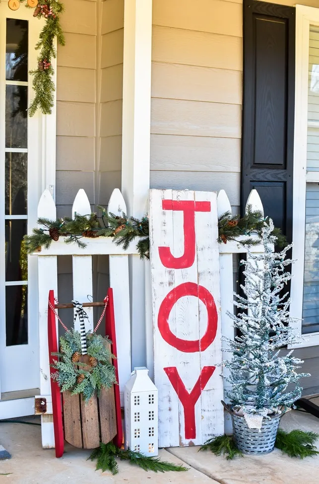 Farmhouse style Christmas front porch with picket fences