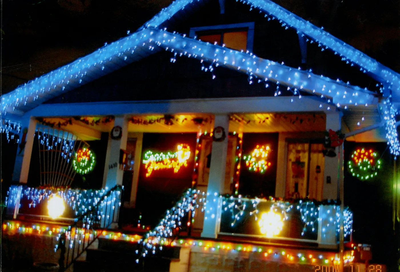 House brightly decorated with blue and multicolored christmas lights
