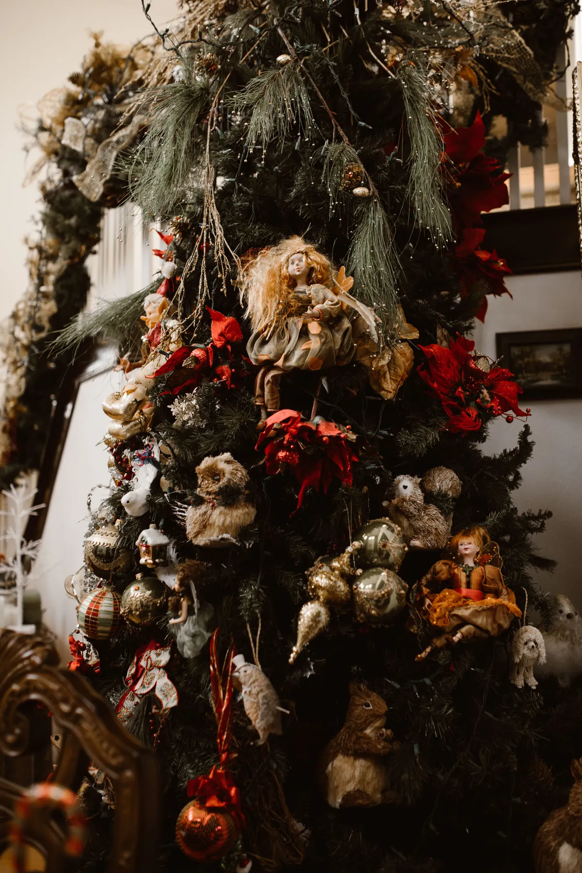 Luxurious Christmas tree adorned with vintage ornaments and festive decorations indoors.