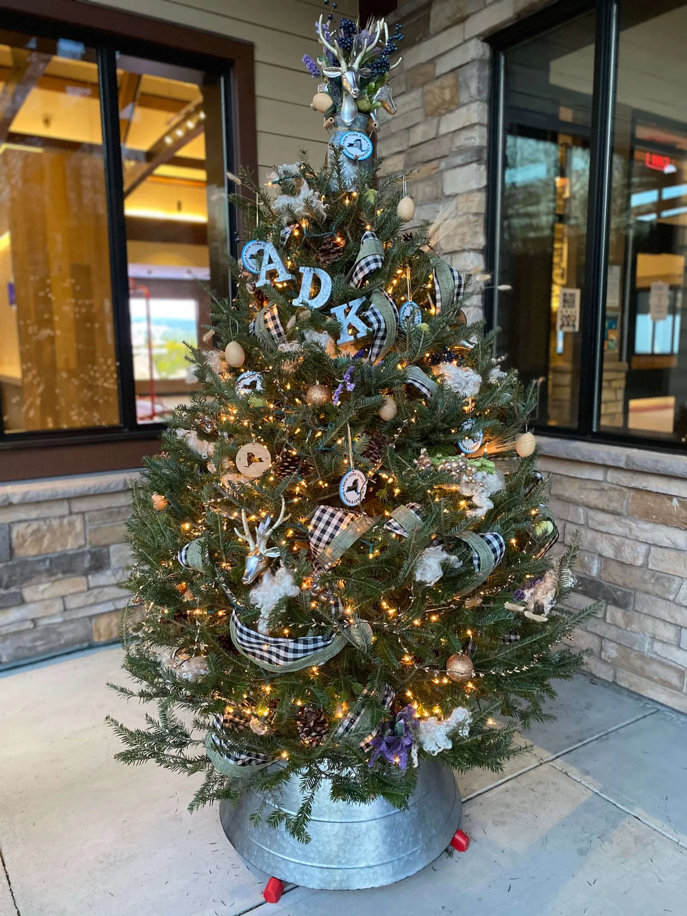 NY grown, themed holiday tree on display at the Adirondacks Welcome Center  - Lake George Regional Chamber of Commerce & CVB