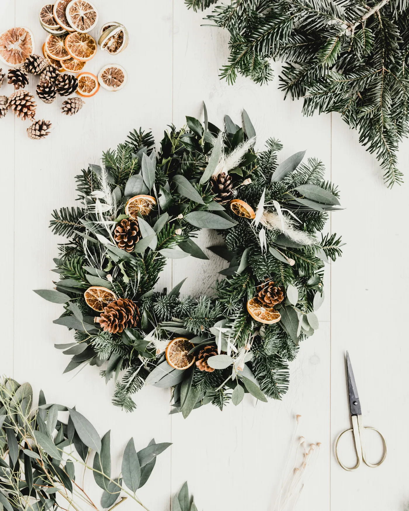 This year I decided to make my own Christmas door wreath using foliage found on walks and dried foliage, acorns and oranges from the photo studio prop cupboard.
