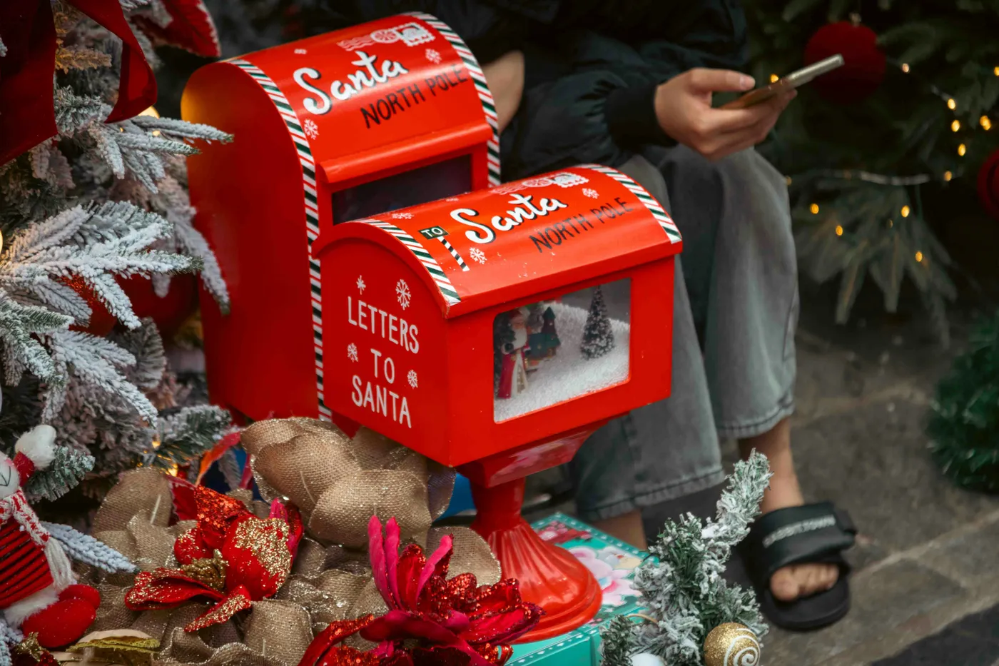 Two red santa mailboxes with christmas decorations