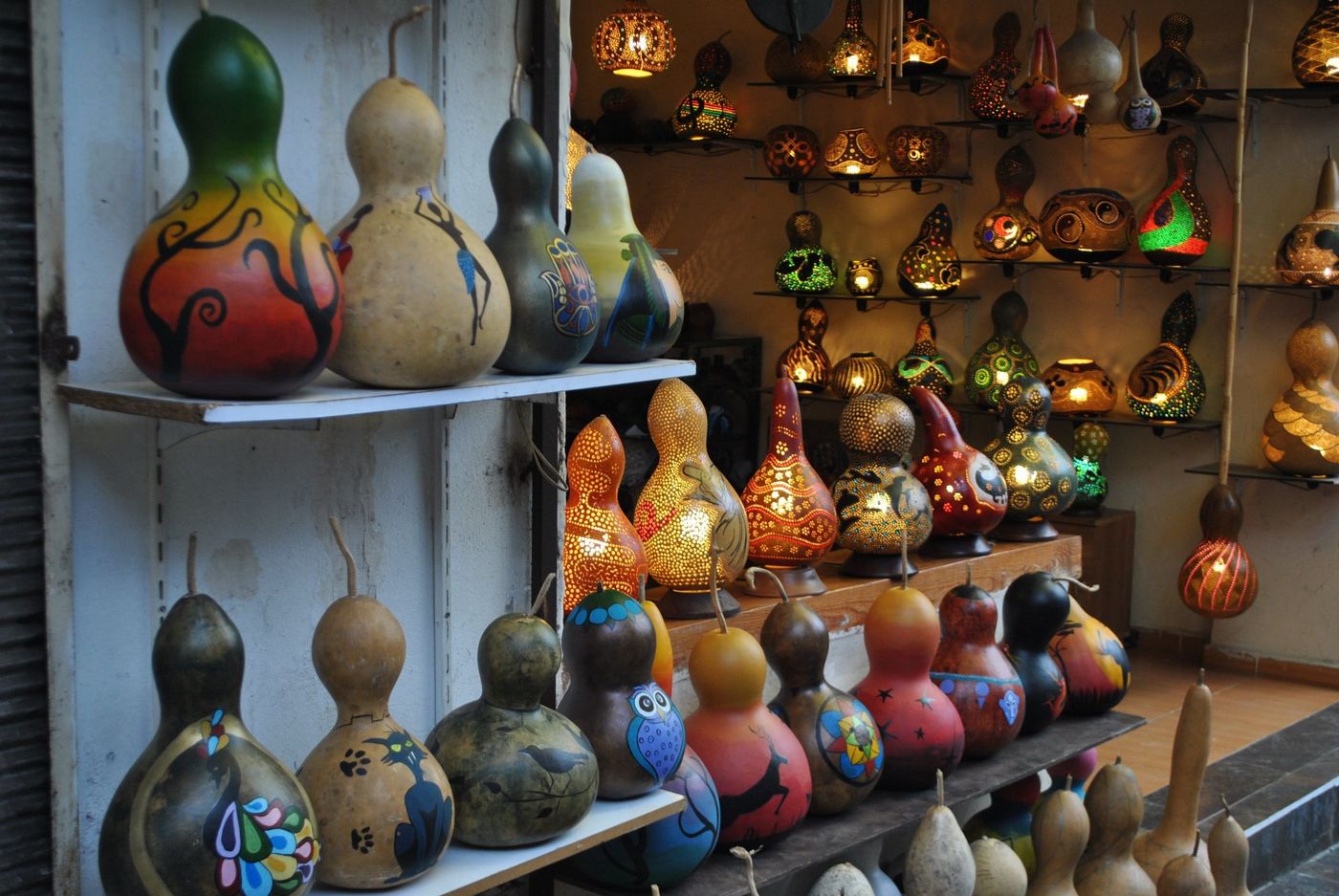 Vibrant display of hand-painted and illuminated gourds in an artisan shop.