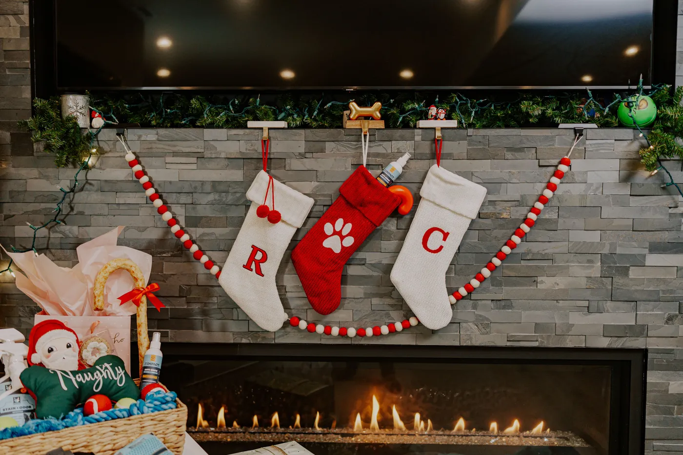 Warm festive fireplace scene with stockings, ornaments, and cozy Christmas decorations.