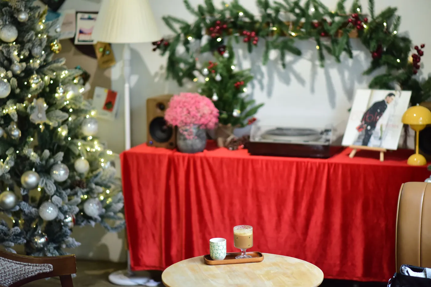 Warm festive living room with Christmas tree, drinks, and decorations.